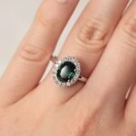 Oval teal sapphire 1.55 carat ring with diamonds 0.16 carats in platinum setting
