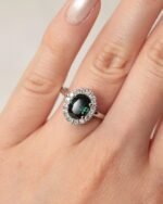Oval teal sapphire 1.55 carat ring with diamonds 0.16 carats in platinum setting